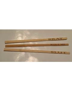 Three wooden chopsticks labeled "brat" rule me" and "slut," and  designed for adult play and couple's bedroom activities.